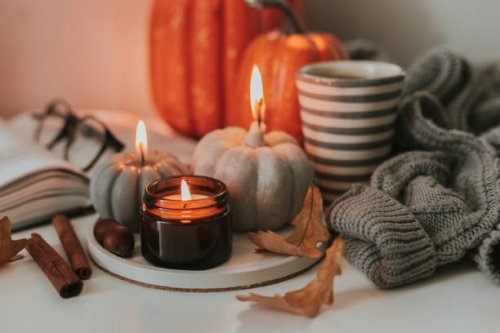 atmospheric candles shape of pumpkin, gray sweater, autumn decor on table. cozy autumn lifestyle, hygge concept. still life. - home decoration stock pictures, royalty-free photos & images
