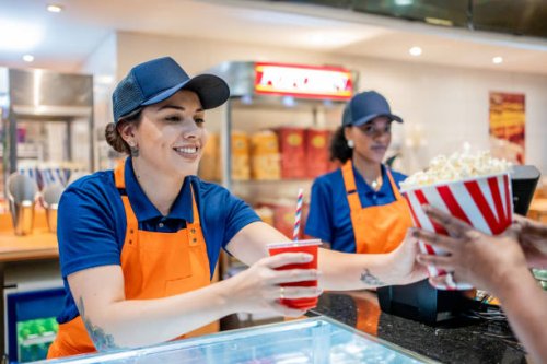 attendant delivering popcorn and soda - junk food stock pictures, royalty-free photos & images