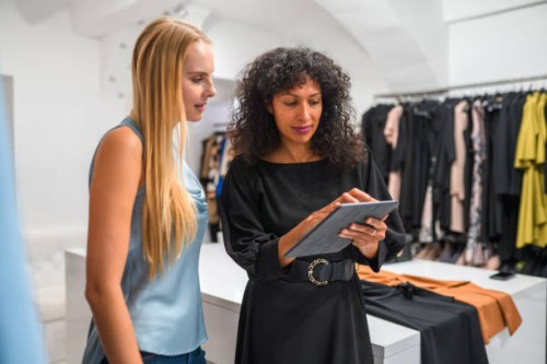 attractive business owner with female client - fashion stock pictures, royalty-free photos & images