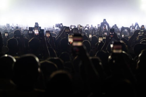 Audience addends Annalisa's concert filming the scene with their smartphone on April 13, 2024 in Naples, Italy.