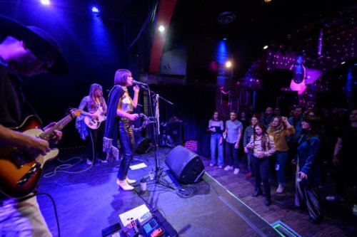 audience dancing to live band performing on stage at small venue - concert stock pictures, royalty-free photos & images