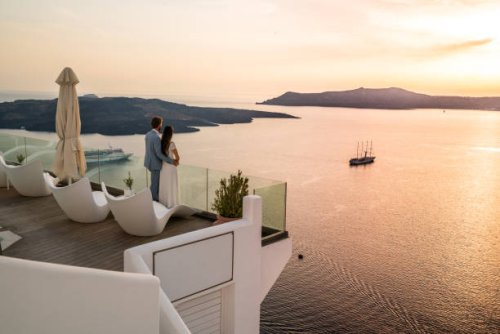 authentic wealth - rich couple standing on terrace with amazing sea view - travel stock pictures, royalty-free photos & images