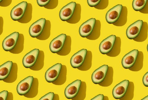 avocado halves pattern with hard shadow and trendy lighting on yellow background - food stock pictures, royalty-free photos & images