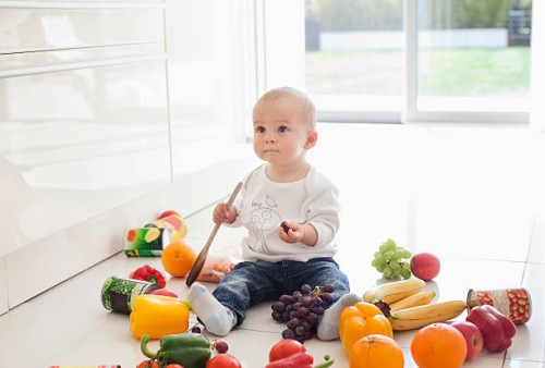 baby making mess on floor with food - food stock pictures, royalty-free photos & images