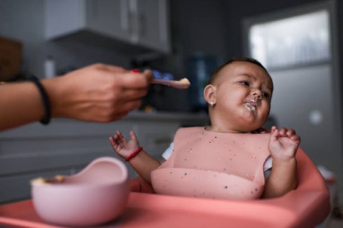 baby sitting in highchair refusing to eat - food stock pictures, royalty-free photos & images