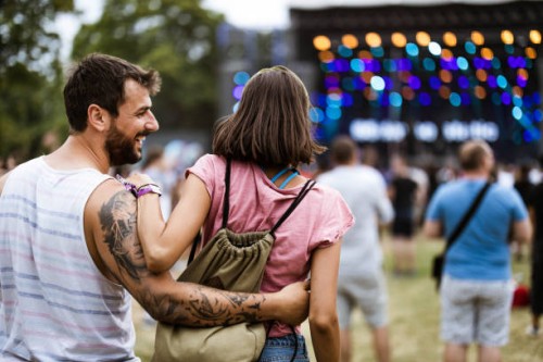back view of happy embraced couple on music concert. - concert stock pictures, royalty-free photos & images