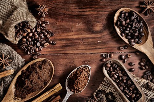 background of coffee beans and grinded coffee on a rustic table - coffee stock pictures, royalty-free photos & images