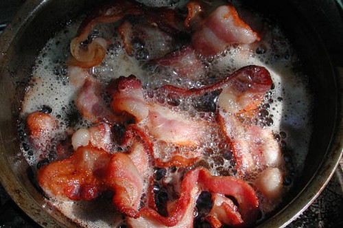 bacon sizzlin' at camp - junk food stock pictures, royalty-free photos & images