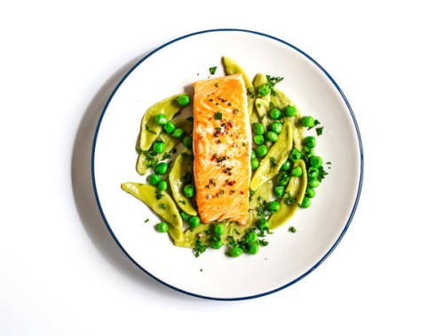 baked salmon with spinach pasta and green peas - food stock pictures, royalty-free photos & images