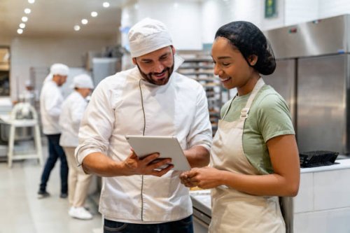 baker training a new employee at the bakery - food stock pictures, royalty-free photos & images