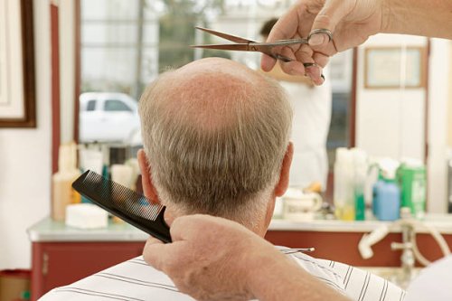 balding man at barbershop - hairstyle photos et images de collection