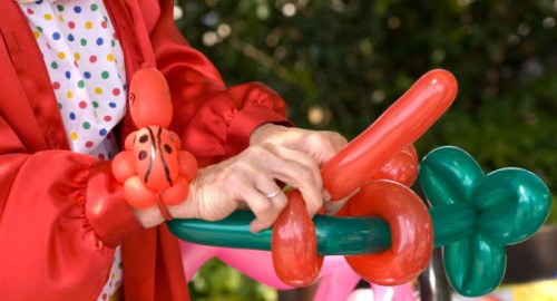 balloon animal making by clown performer at family birthday party - garden decoration stock pictures, royalty-free photos & images