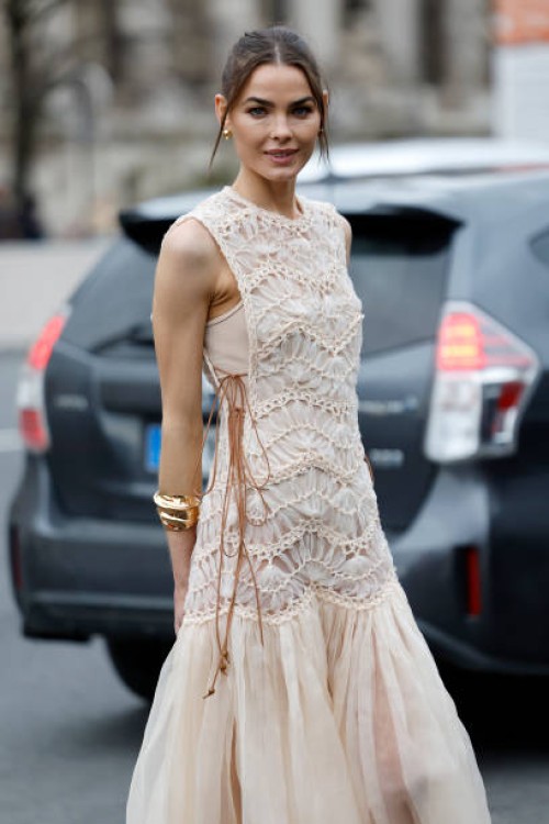 Bambi Northwood-Blyth wears beige maxi dress with decorated top part and tulle skirt, gold bracelet, outside Zimmermann, during the Womenswear...