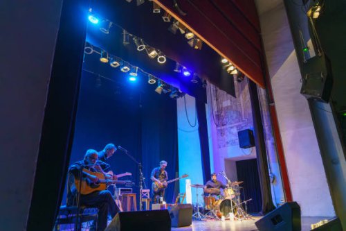 band of four musicians playing on stage - concert stock pictures, royalty-free photos & images