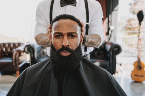 barber cutting hair in barber shop - hairstyle stock-fotos und bilder