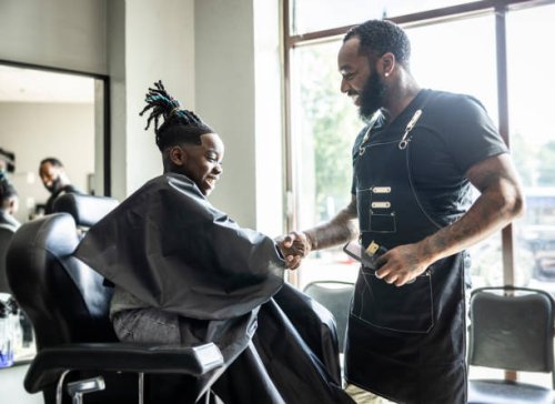 barber cutting young boys hair in barbershop - hairstyle stock pictures, royalty-free photos & images