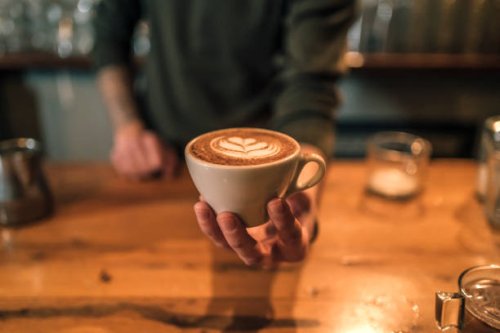 barista holding a cup of espresso coffee - coffee stock pictures, royalty-free photos & images
