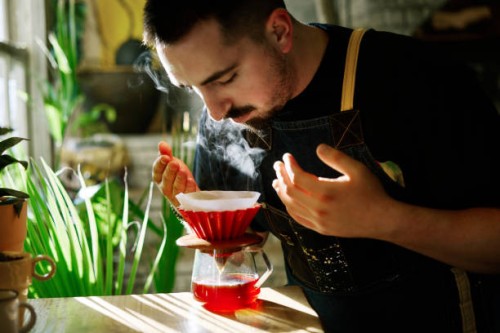 barista smelling the filter coffee while making it - food stock pictures, royalty-free photos & images