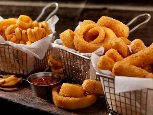 baskets of onion rings, curly fries and cheese sticks - junk food stock pictures, royalty-free photos & images