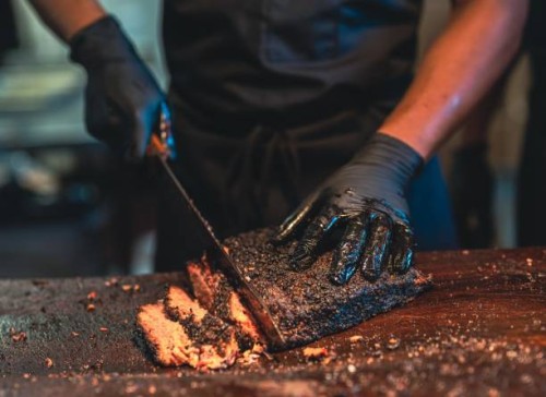 bbq chef cuts deliciously tender smoked brisket slices. - food stock pictures, royalty-free photos & images