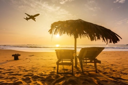 beach at a tropical resort at sunset and a flying plane. summer vacation on tropical resort - home decoration stock pictures, royalty-free photos & images