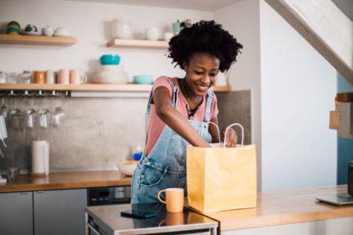 beautiful african-american woman preparing to eat her ordered food - junk food stock pictures, royalty-free photos & images