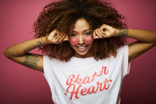 beautiful afro caribbean young woman in summer clothes against pink background. - fashion stock pictures, royalty-free photos & images