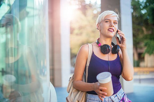 beautiful blonde young woman talking on smartphone - junk food stock pictures, royalty-free photos & images