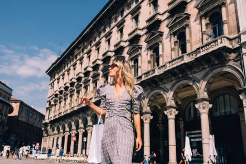 beautiful businesswoman with sunglasses looking away while walking on the street - fashion stock pictures, royalty-free photos & images