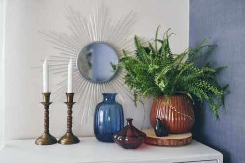 beautiful design of a white shelf or nightstand. candles, a mirror and green flower, glass vase - home decoration stock pictures, royalty-free photos & images