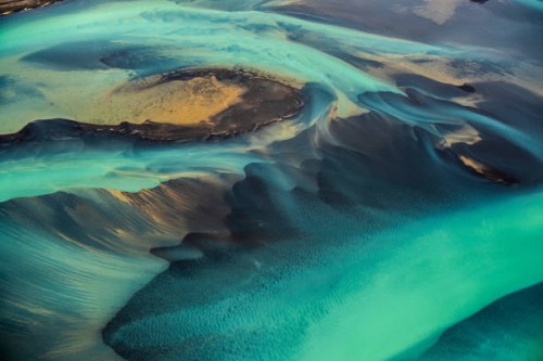 beautiful emerald-colored glacial rivers of iceland, taken from a helicopter - travel stock pictures, royalty-free photos & images