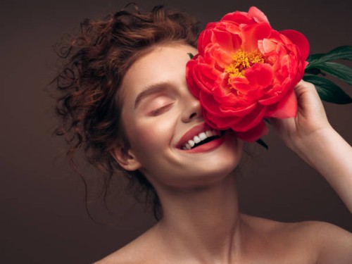 beautiful emotional woman holding a flower - fashion stock pictures, royalty-free photos & images