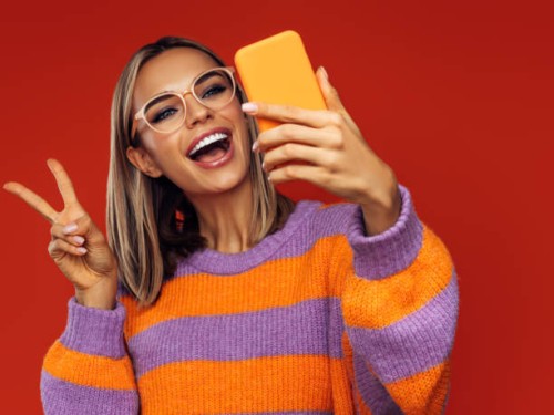 beautiful emotional woman using smart phone - fashion stock pictures, royalty-free photos & images