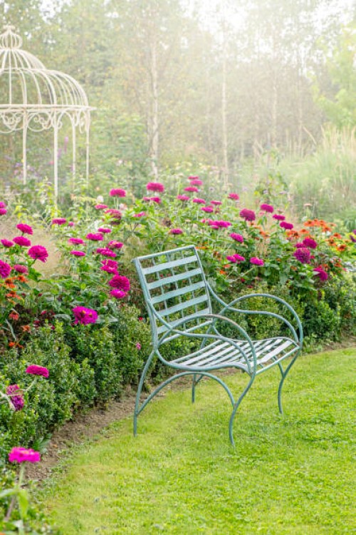 beautiful english cottage garden in soft summer sunshine with wrought iron seat and pergola garden features - garden decoration photos et images de collection