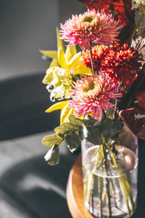beautiful exotic flower bouquet with chrysanthemum and daisies in a transparent glass vase - garden decoration stock pictures, royalty-free photos & images