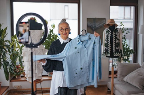 beautiful fashion and style granfluencer woman making live video on social media. senior social media influencer creating fashion content, talking about newest fashion trends. - fashion stock pictures, royalty-free photos & i