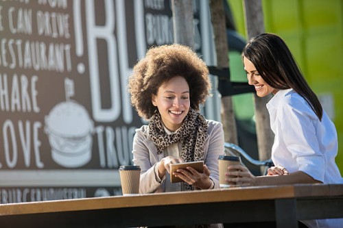 beautiful females on a coffee break - junk food stock pictures, royalty-free photos & images