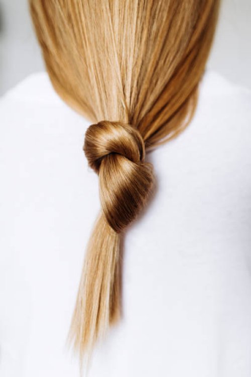 beautiful healthy long hair tied in a knot. - hairstyle stock pictures, royalty-free photos & images