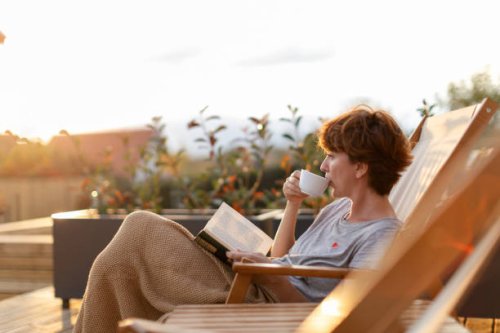beautiful woman enjoying on patio at home - coffee stockfoto's en -beelden