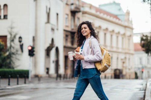 beautiful woman having her breakfast in the city - junk food stock pictures, royalty-free photos & images