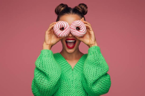 beautiful woman holding donuts - food stockfoto's en -beelden