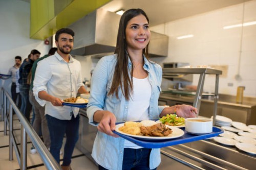 beautiful woman leaving the buffet service with her tray ready to eat lunch - food stock pictures, royalty-free photos & images
