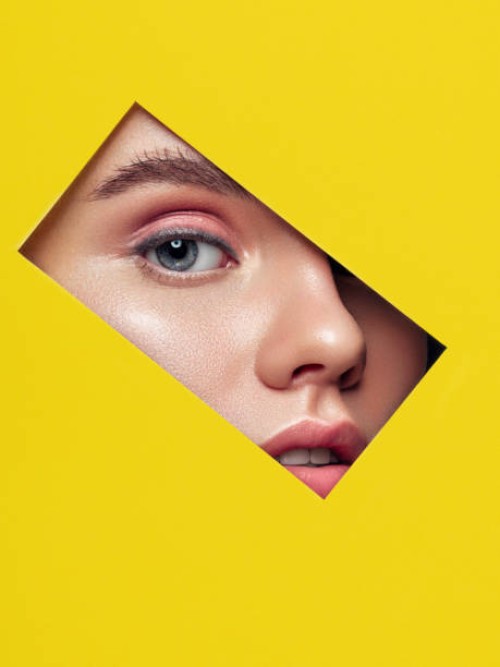beautiful woman looking through a rectangle hole - fashion stock pictures, royalty-free photos & images