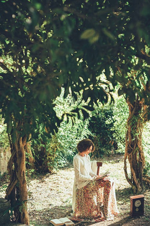 beautiful woman reading a book at the magical park - garden decoration stock pictures, royalty-free photos & images