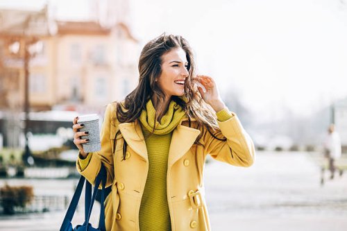 beautiful woman walking outdoors on a sunny day - junk food stock pictures, royalty-free photos & images