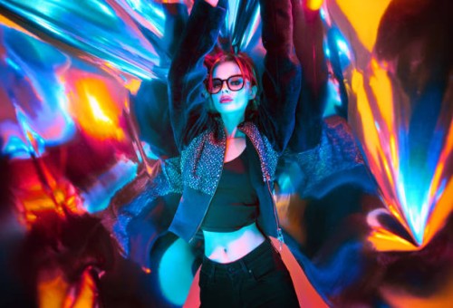 beautiful woman with eyeglasses standing against colored plastic wrap with neon lights,china - fashion photos et images de collection
