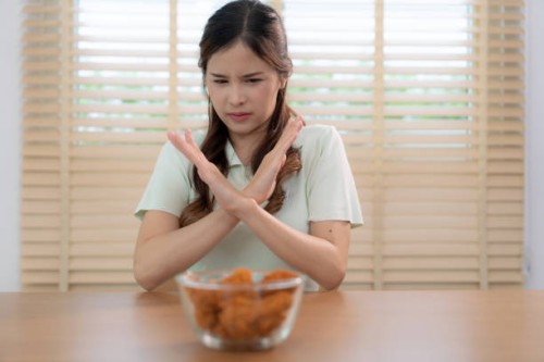 beautiful young asian woman refuses to eat junk food or fast food. - junk food stock pictures, royalty-free photos & images