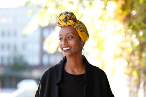 beautiful, young, happy muslim woman in urban setting - fashion stock pictures, royalty-free photos & images