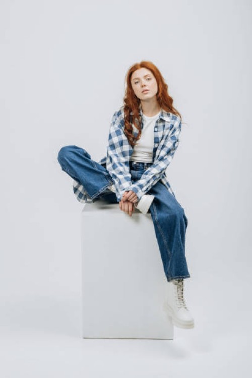 beautiful young model posing sitting in studio on cube white background casual new clothes catalog. fashion and trend concept - fashion stock pictures, royalty-free photos & images