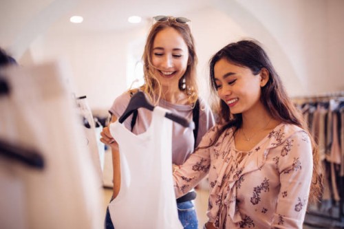 beautiful young multi-ethnic women shopping in a boutique for clothes - fashion stock pictures, royalty-free photos & images